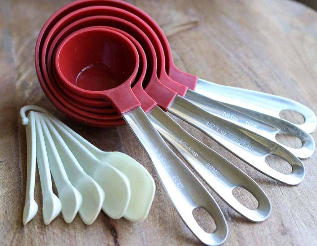 measuring cups and spoons on a wooden board