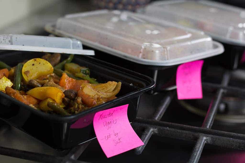 black containers with veggies and sticky notes