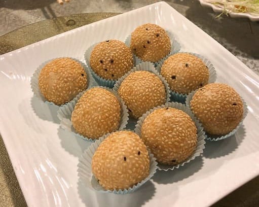 Sesame balls on a white square plate at a tea house in Tin Hau