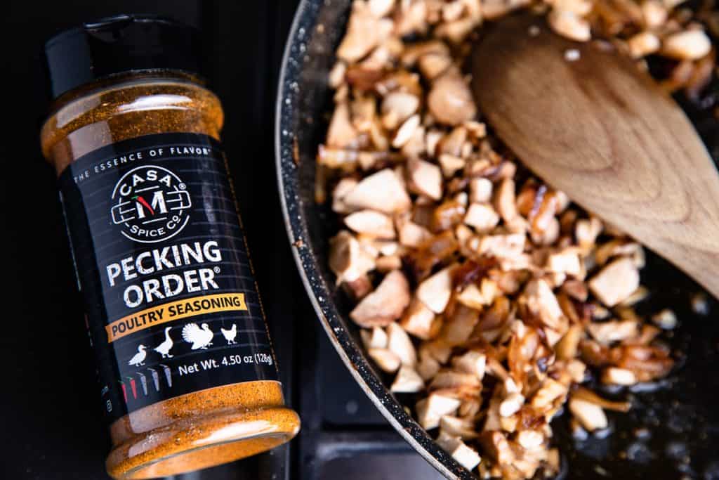 Pecking Order spice next to mushroom mixture with spoon in pan