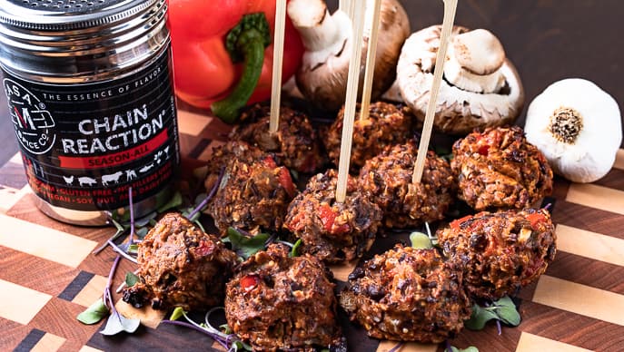 meat balls on a board with skewers and Chain Reaction spice